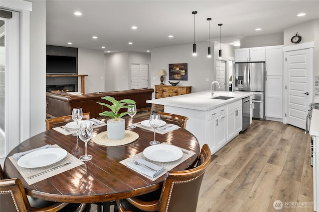 101 Wren Loop SW, Mattawa, WA 99349 - dining space with light wood finished floors, recessed lighting, and a glass covered fireplace