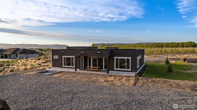 101 Wren Loop SW, Mattawa, WA 99349 - back of property with a mountain view, a patio area, and stucco siding