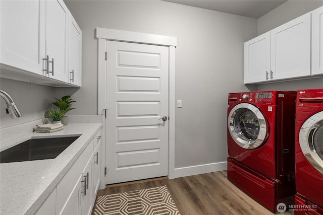 101 Wren Loop SW, Mattawa, WA 99349 - laundry area featuring washer and dryer, dark wood-type flooring, and cabinet space