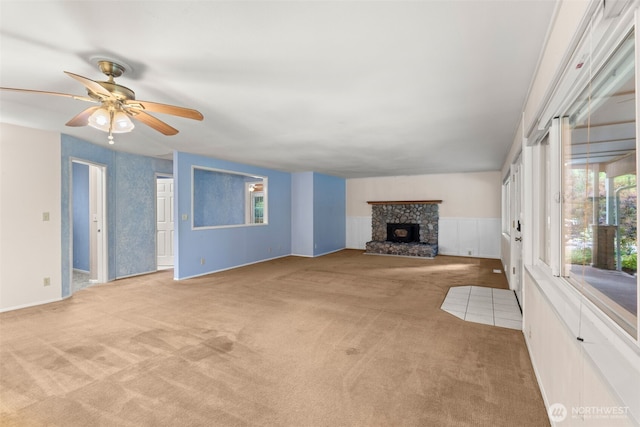 9390 NE Wardwell Rd, Bainbridge Island, WA 98110 - unfurnished living room featuring light colored carpet, a fireplace, ceiling fan, and wainscoting