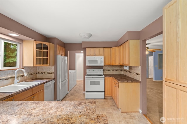 9390 NE Wardwell Rd, Bainbridge Island, WA 98110 - kitchen with white appliances, independent washer and dryer, light brown cabinetry, decorative backsplash, and glass insert cabinets