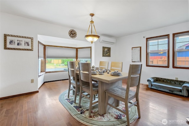 10208 D St E, Tacoma, WA 98445 - dining room featuring a wall mounted air conditioner and wood finished floors
