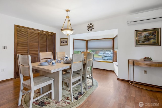 10208 D St E, Tacoma, WA 98445 - dining area featuring a wall mounted air conditioner and wood finished floors