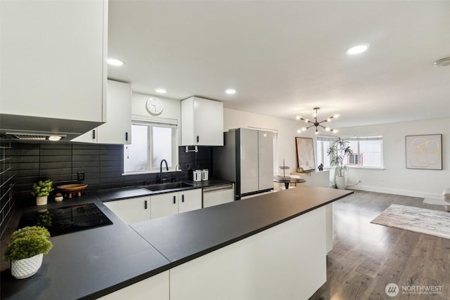 5467 16th Ave SW, Seattle, WA 98106 - kitchen featuring black electric cooktop, dark countertops, stainless steel dishwasher, decorative backsplash, and recessed lighting