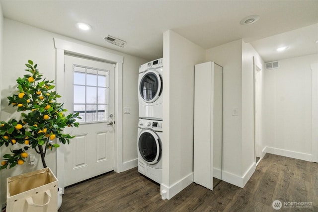 5467 16th Ave SW, Seattle, WA 98106 - laundry area with stacked washer and clothes dryer, dark wood-type flooring, and recessed lighting