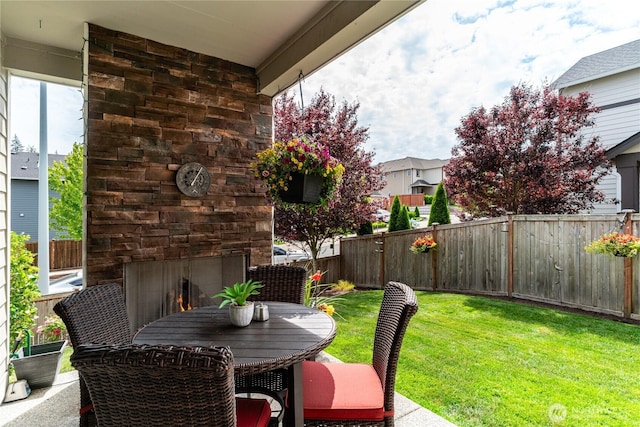 1448 101st Ave SE, Lake Stevens, WA 98258 - fenced backyard featuring an outdoor stone fireplace, a patio area, and outdoor dining area
