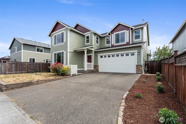 15204 Kayla St SE, Yelm, WA 98597 - view of front of property featuring an attached garage, stone siding, and driveway