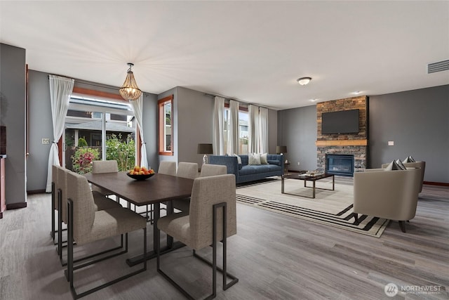 15204 Kayla St SE, Yelm, WA 98597 - dining area with a fireplace and light wood finished floors