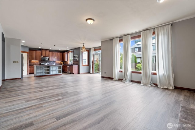 15204 Kayla St SE, Yelm, WA 98597 - unfurnished living room featuring light wood finished floors and recessed lighting