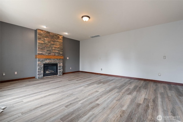 15204 Kayla St SE, Yelm, WA 98597 - unfurnished living room with wood finished floors and a fireplace