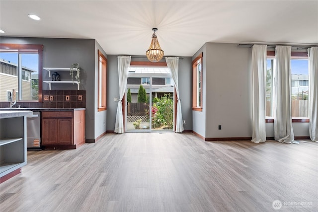 15204 Kayla St SE, Yelm, WA 98597 - unfurnished dining area with light wood-style floors, a chandelier, and recessed lighting