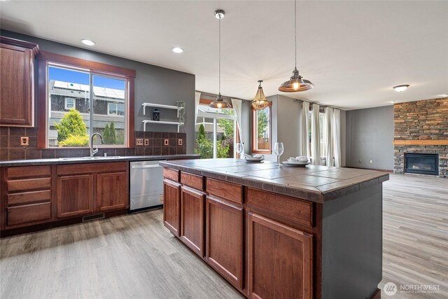 15204 Kayla St SE, Yelm, WA 98597 - kitchen with stainless steel dishwasher, light wood-style flooring, plenty of natural light, tasteful backsplash, and recessed lighting