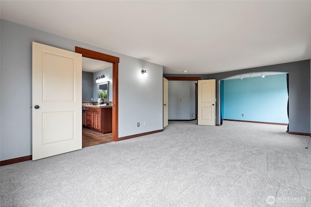 15204 Kayla St SE, Yelm, WA 98597 - carpeted empty room with baseboards and arched walkways