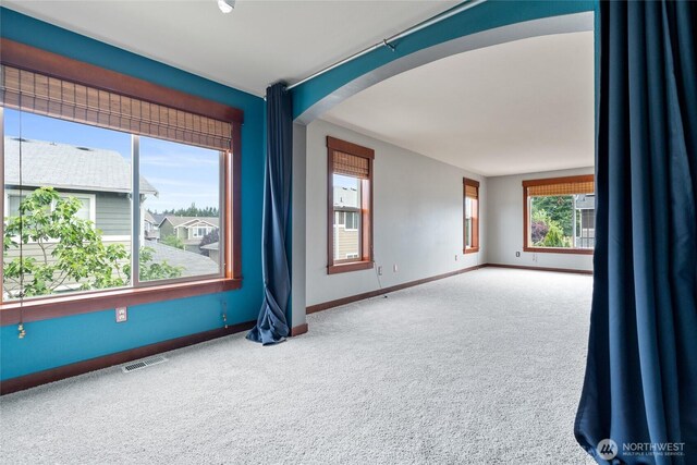 15204 Kayla St SE, Yelm, WA 98597 - carpeted empty room with arched walkways and baseboards
