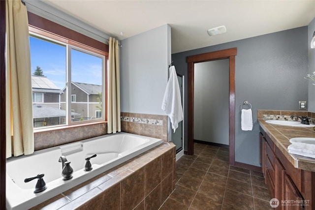 15204 Kayla St SE, Yelm, WA 98597 - full bathroom with a garden tub, double vanity, a stall shower, and tile patterned floors