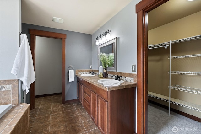 15204 Kayla St SE, Yelm, WA 98597 - full bathroom featuring double vanity, a baseboard heating unit, and a relaxing tiled tub