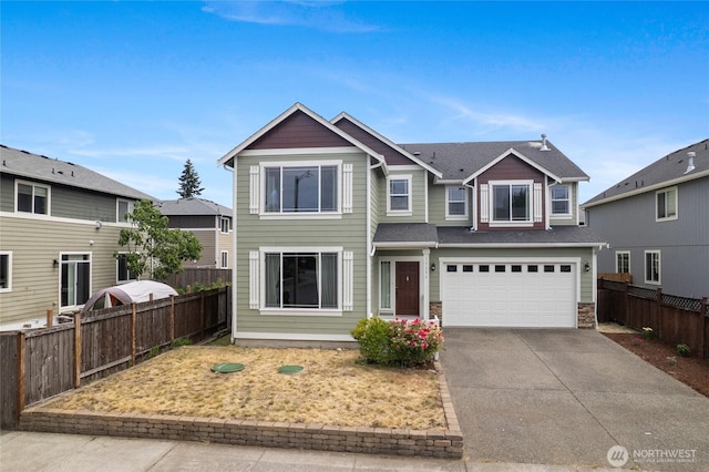 15204 Kayla St SE, Yelm, WA 98597 - view of front of home with concrete driveway, a garage, and stone siding