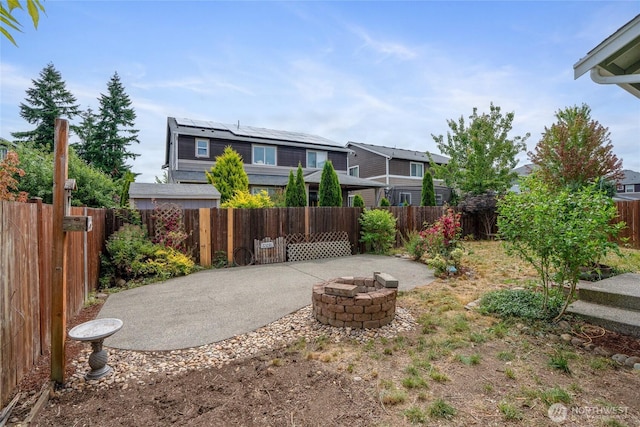 15204 Kayla St SE, Yelm, WA 98597 - fenced backyard featuring a fire pit and a patio area