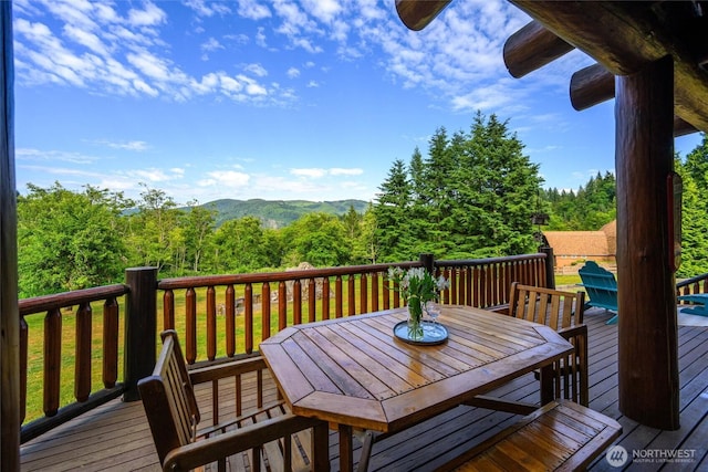 3130 S Bay Vista Dr, Sedro Woolley, WA 98284 - wooden terrace featuring outdoor dining area, a forest view, and a mountain view
