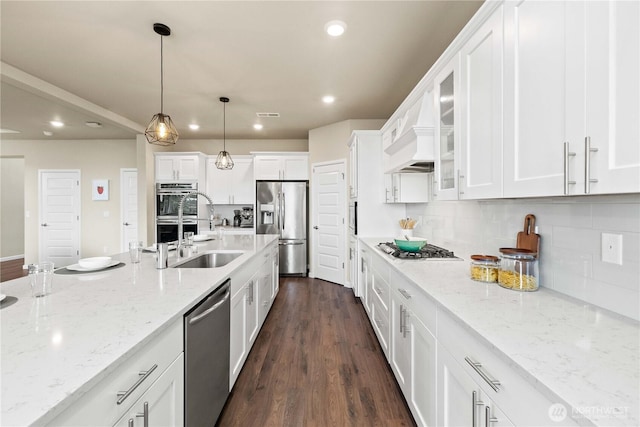 25613 204th Pl SE, Covington, WA 98042 - kitchen with appliances with stainless steel finishes, recessed lighting, white cabinetry, hanging light fixtures, and light stone counters
