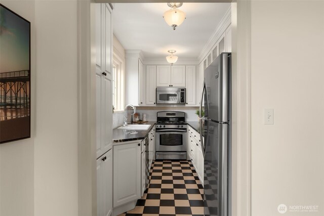 405 Prospect St Unit 201, Seattle, WA 98109 - kitchen featuring appliances with stainless steel finishes, dark countertops, white cabinets, and tile patterned floors