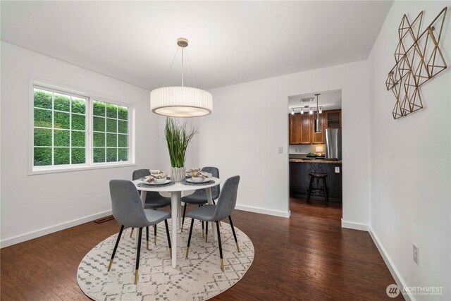 608 14th St SW, Puyallup, WA 98371 - dining space with dark wood-style flooring and baseboards