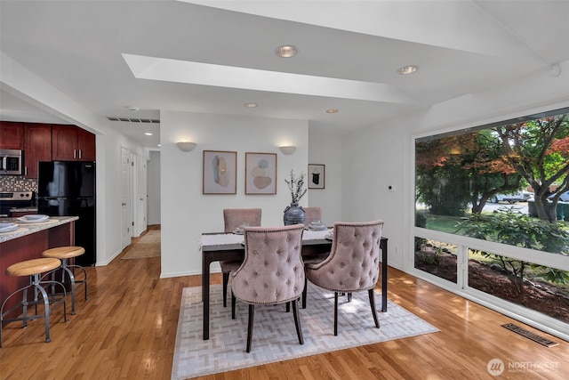 18256 45th Ave S, Seatac, WA 98188 - dining room featuring light wood-style floors, a skylight, and recessed lighting