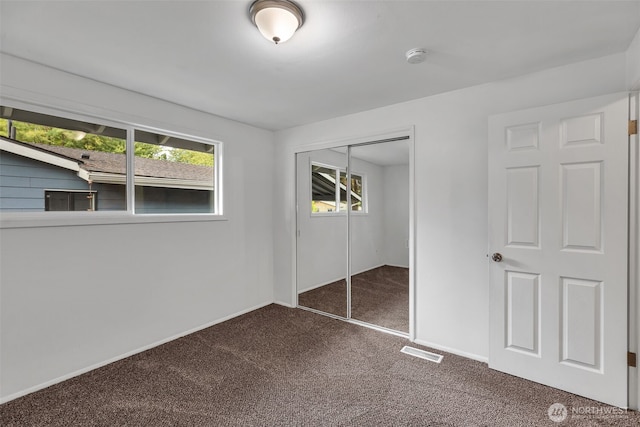 18256 45th Ave S, Seatac, WA 98188 - unfurnished bedroom featuring dark carpet and a closet