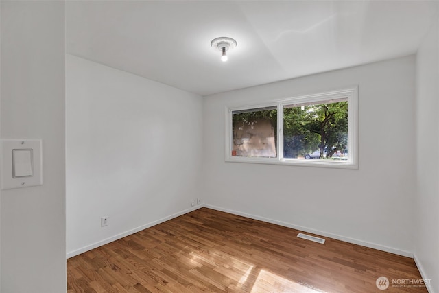18256 45th Ave S, Seatac, WA 98188 - unfurnished room featuring wood finished floors and baseboards