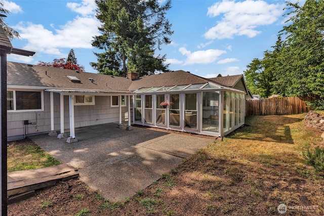 18256 45th Ave S, Seatac, WA 98188 - rear view of property featuring a sunroom, a shingled roof, a patio, and a chimney