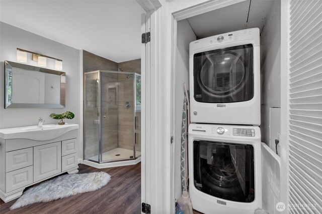 10656 SE 287th St, Auburn, WA 98092 - laundry room with stacked washing machine and dryer and dark wood finished floors