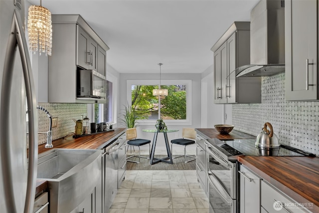10656 SE 287th St, Auburn, WA 98092 - kitchen with wooden counters, wall chimney exhaust hood, stainless steel appliances, and gray cabinets