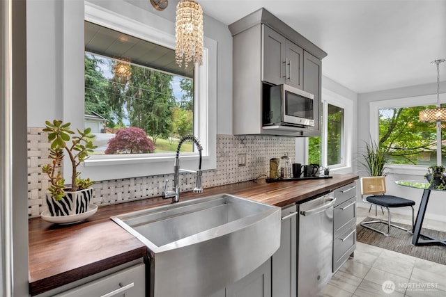 10656 SE 287th St, Auburn, WA 98092 - kitchen featuring butcher block counters, appliances with stainless steel finishes, a chandelier, gray cabinets, and backsplash