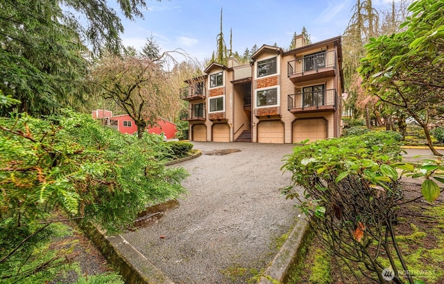 17424 NE 88th Pl Unit B24, Redmond, WA 98052 - view of front of property with an attached garage, a balcony, driveway, and a chimney