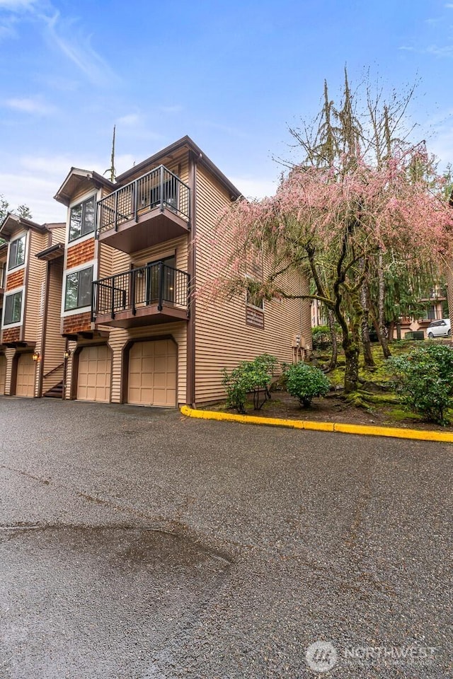 17424 NE 88th Pl Unit B24, Redmond, WA 98052 - view of front of property with a balcony, a garage, and driveway