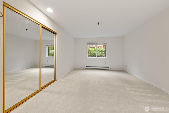 17424 NE 88th Pl Unit B24, Redmond, WA 98052 - carpeted spare room with a baseboard heating unit, healthy amount of natural light, and a pendent fire sprinkler