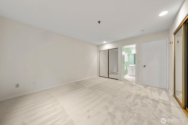 17424 NE 88th Pl Unit B24, Redmond, WA 98052 - unfurnished bedroom featuring light carpet, recessed lighting, and ensuite bathroom