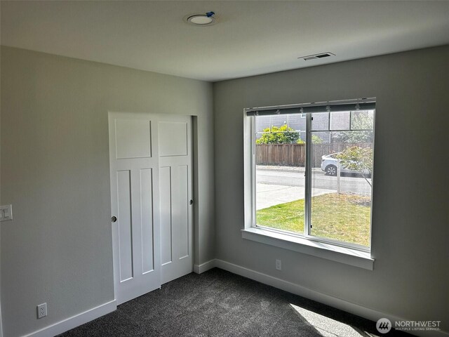 2011 85th Street Ct E, Tacoma, WA 98445 - unfurnished bedroom featuring multiple windows and dark carpet