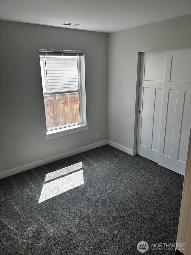 2011 85th Street Ct E, Tacoma, WA 98445 - unfurnished bedroom featuring dark colored carpet and baseboards