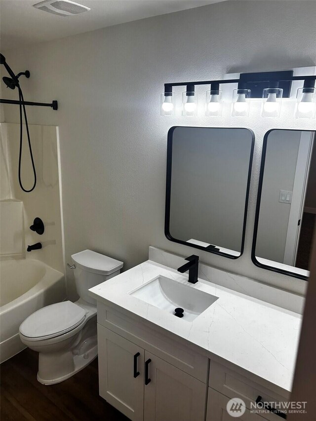 2011 85th Street Ct E, Tacoma, WA 98445 - full bath featuring vanity, washtub / shower combination, and wood finished floors
