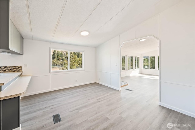138 Trestle View Ln, Dryden, WA 98821 - unfurnished dining area with light wood-style flooring, a textured ceiling, and lofted ceiling