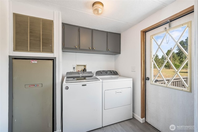 138 Trestle View Ln, Dryden, WA 98821 - washroom with cabinet space, separate washer and dryer, and light wood finished floors