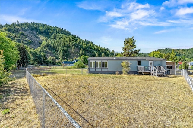 138 Trestle View Ln, Dryden, WA 98821 - view of front facade featuring a fenced backyard, a forest view, and a deck with mountain view