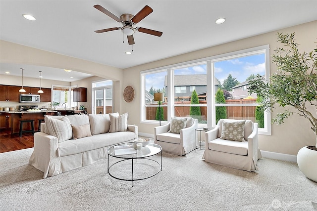 9225 225th Ave E, Buckley, WA 98321 - living room with recessed lighting, ceiling fan, arched walkways, and wood finished floors