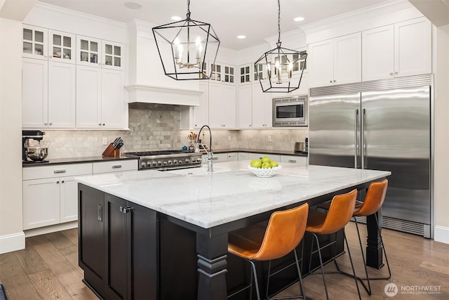11050 SE 30th St, Bellevue, WA 98004 - kitchen featuring built in appliances, a chandelier, dark wood-type flooring, crown molding, and glass insert cabinets
