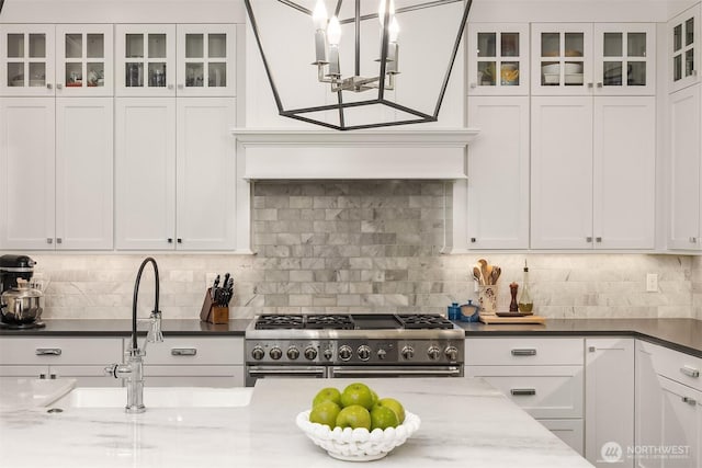 11050 SE 30th St, Bellevue, WA 98004 - kitchen with double oven range, white cabinetry, glass insert cabinets, and decorative backsplash