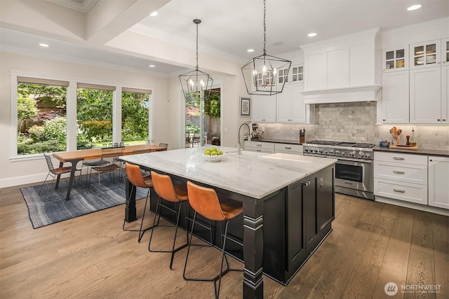 11050 SE 30th St, Bellevue, WA 98004 - kitchen with stainless steel range, white cabinets, dark wood-type flooring, recessed lighting, and ornamental molding
