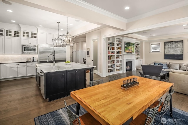 11050 SE 30th St, Bellevue, WA 98004 - dining room featuring ornamental molding, dark wood-style floors, a lit fireplace, recessed lighting, and a chandelier