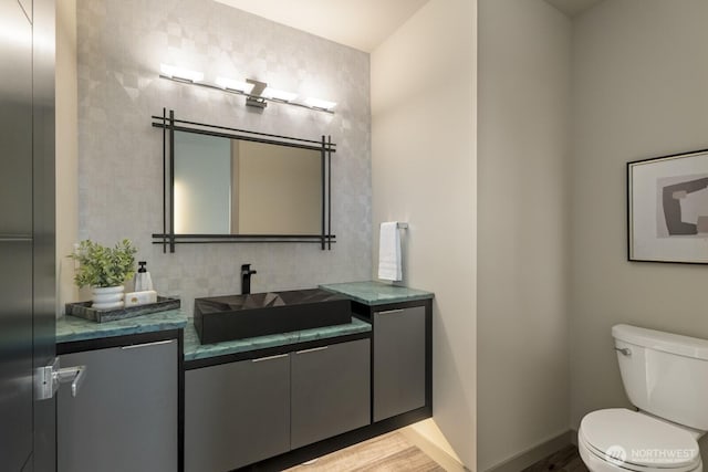 5009 Ocean Ave, Everett, WA 98203 - half bath featuring vanity, decorative backsplash, and wood finished floors