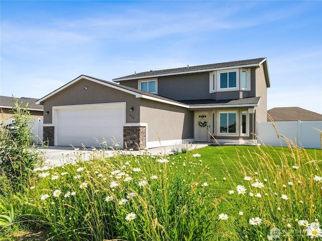 920 E Mt Adams St, Othello, WA 99344 - traditional-style home featuring stone siding, a garage, and stucco siding